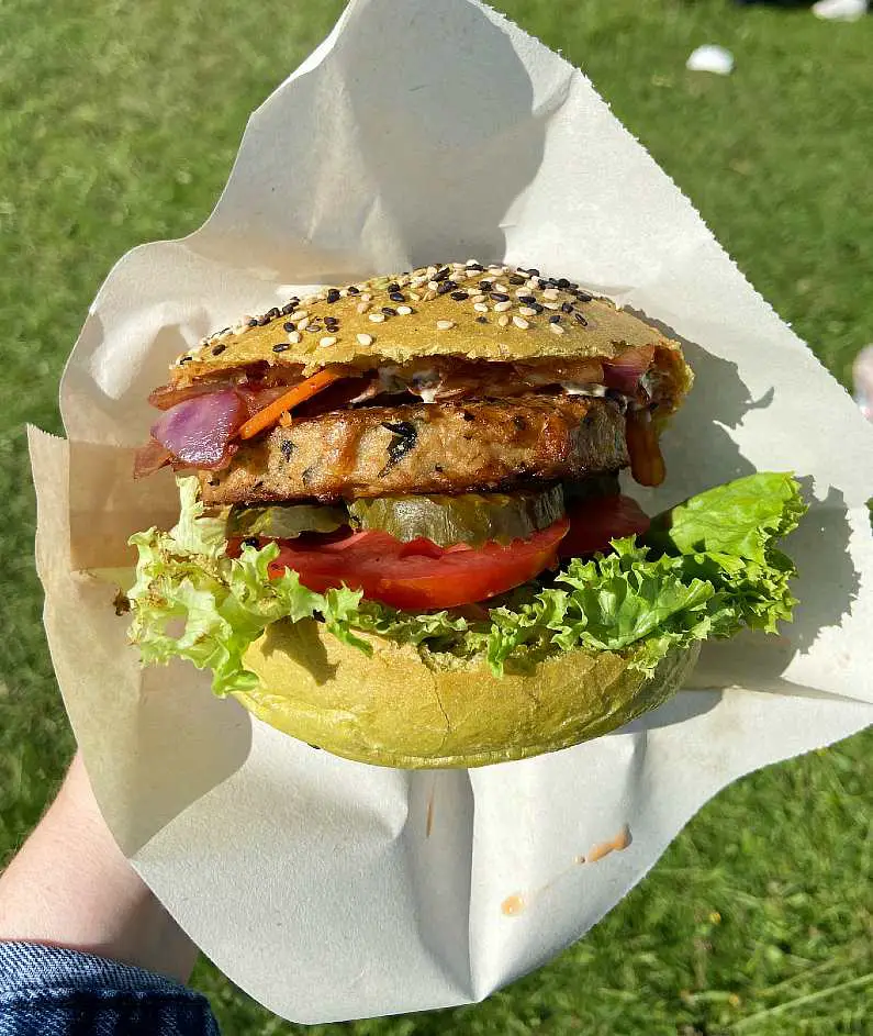Seaweed burger up close with tomatoes, lettuce, pickles and kimchi