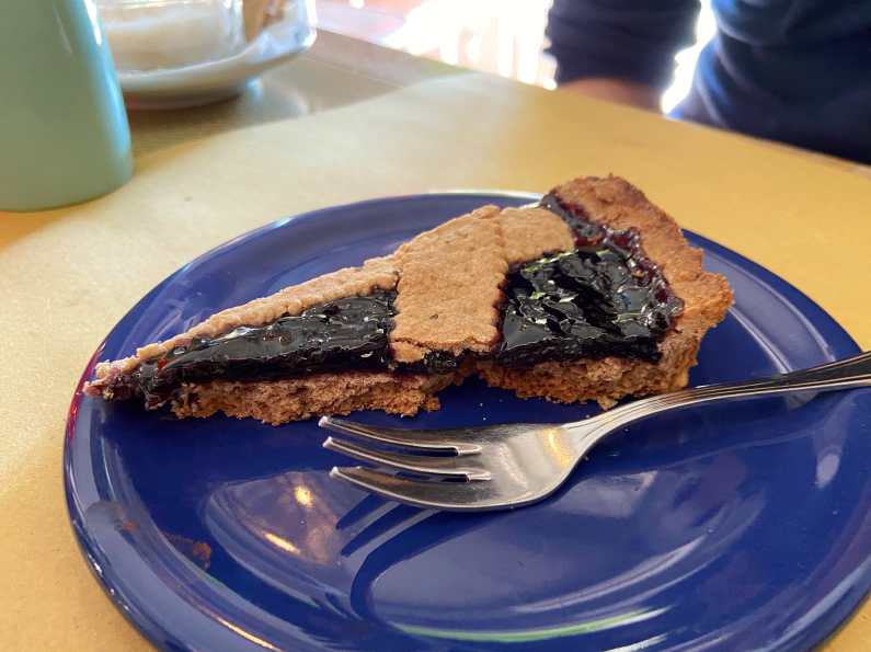 Slice of vegan berry pie on a blue plate