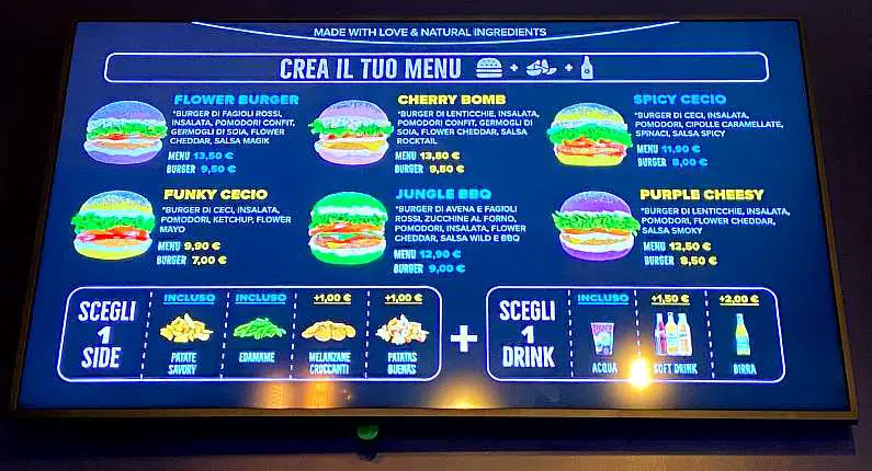 Burger menu on a digital board in Italian above the check out counter in Flower Burger