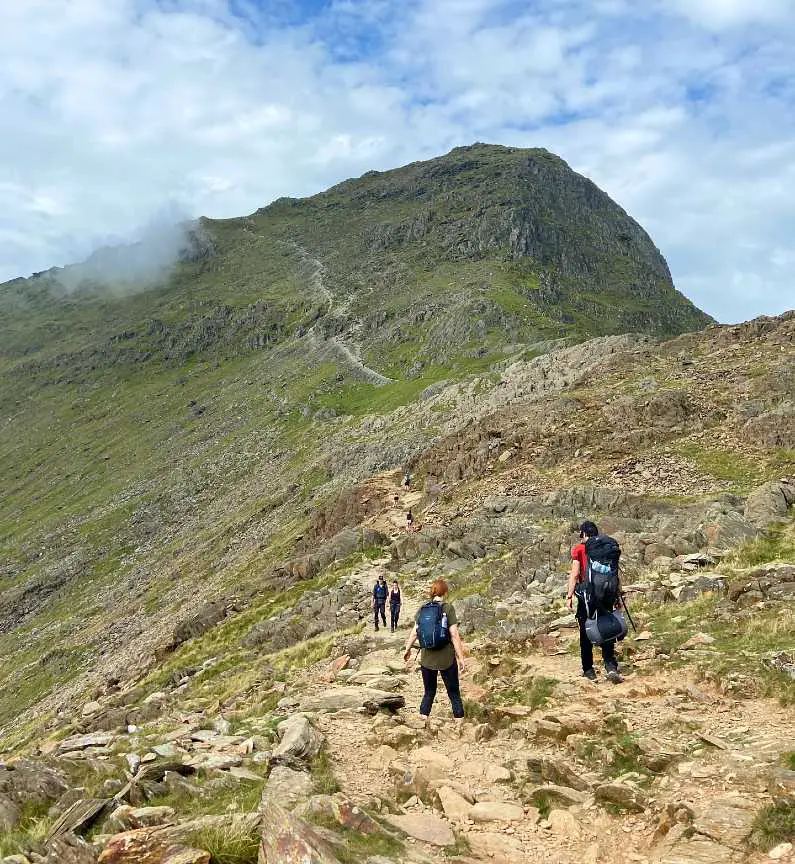 Final ascent to the summit of Snowdon on the Watkin Path with the green peak of the summit in the background