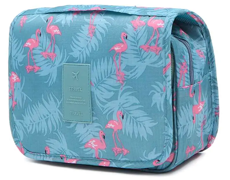 Light blue travel wash bag with pink flamingoes on it